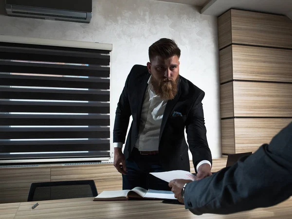 Young bearded businessman in office late night work