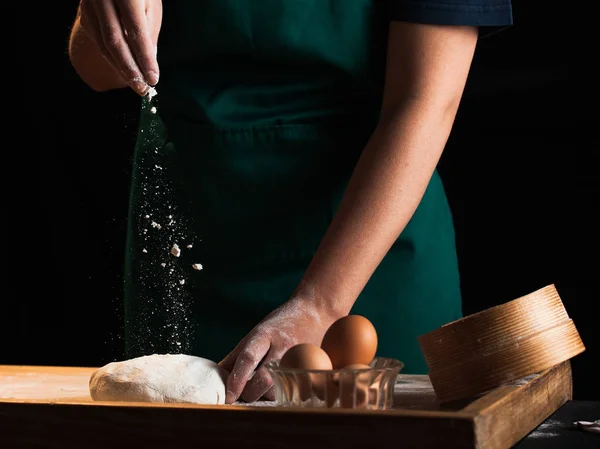 Hands of a chef baker woman kneading dough