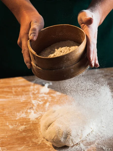 Hands of a chef baker woman kneading dough