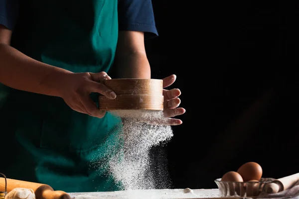 Hands of a chef baker woman kneading dough