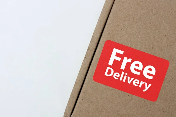 free delivery, business,online shopping, ecommerce and delivery service concept - brown box with note \