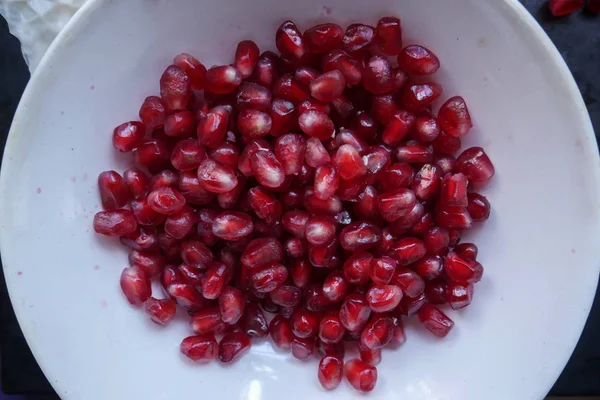 Pomegranate fruits in a white plate — Stock Photo, Image