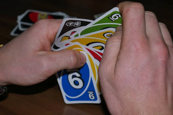 Uno cards in hand, card game — Stock Photo, Image