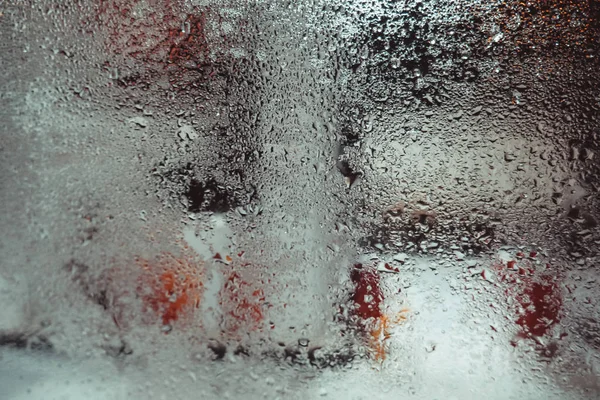 Water drops on glass close up in night city — Stock Photo, Image