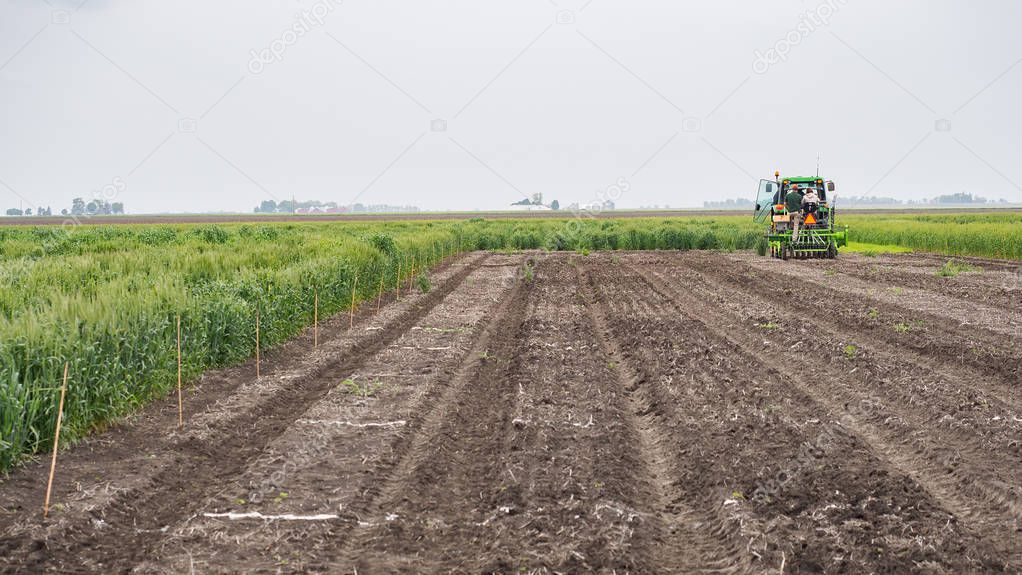 Tractor seeding an open plot of land