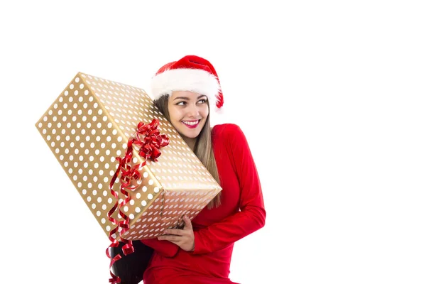 兴奋的年轻女子拿着一个大礼物在白色 圣诞节时间 图库照片