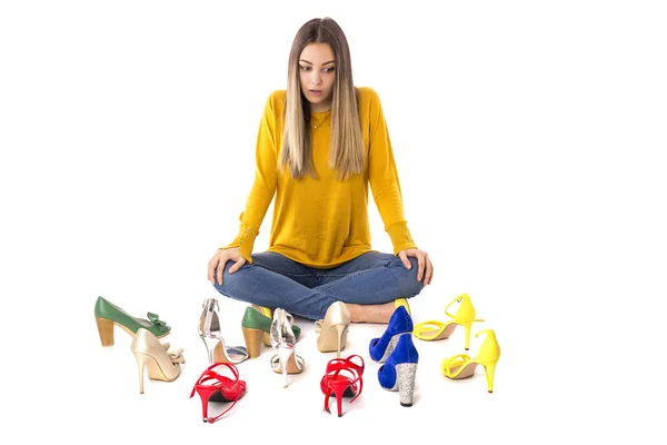 白に対して靴の多くのペアの間に床の上に座って 代女性の肖像画 消費者概念 — ストック写真