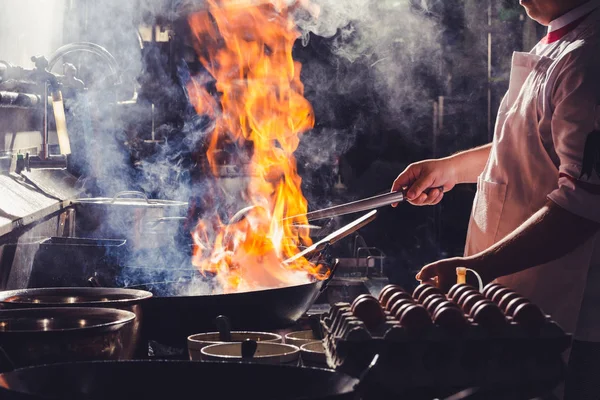Chef stir fry in wok — Stock Photo, Image