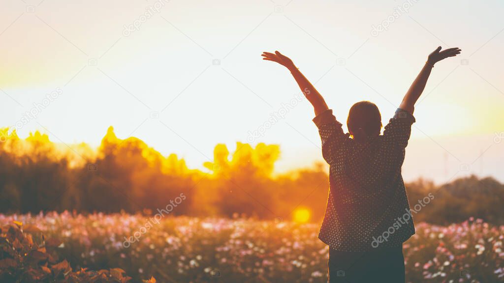 cheering woman open arms at sunrise flowers garden,Nature of Life