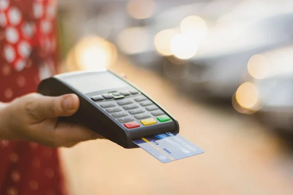 Paying via a credit card swipe machine, new normal shopping concept