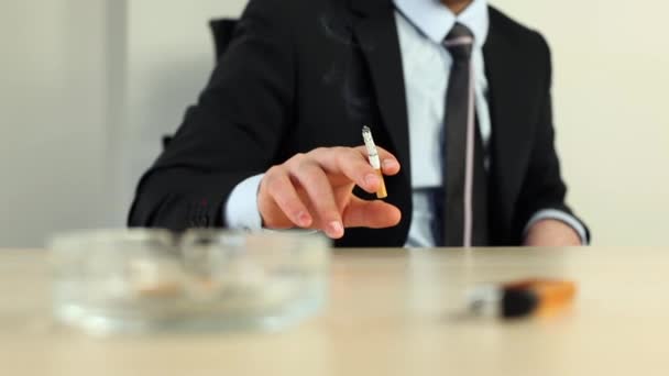 Businessman smoking cigarette in office — Stock Video