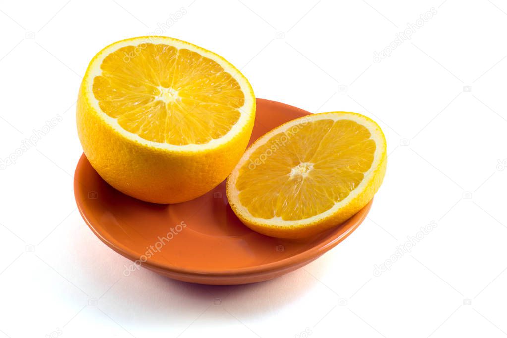 Orange whole and cut in orange plate on white background