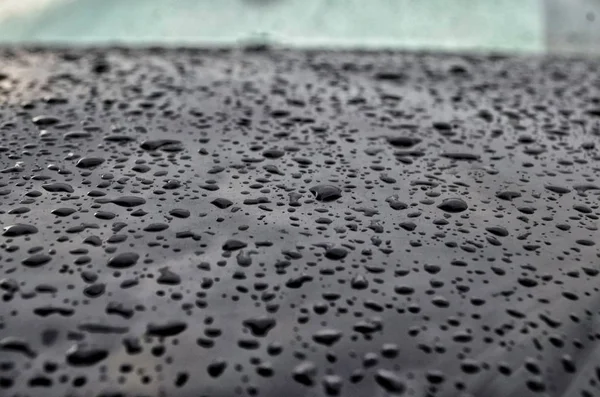 Brilliant raindrops on a car in cloudy weather