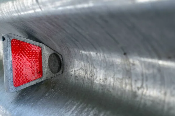 Red reflector on road stop