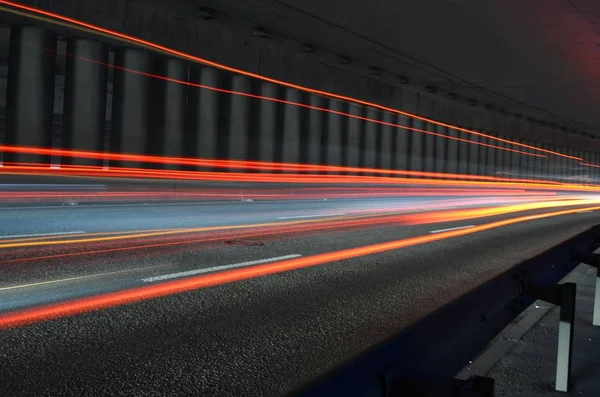 Truck light trails in tunnel. Art image. Long exposure photo taken in a tunnel.