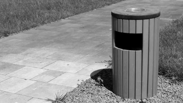Trash can on the street, black and white