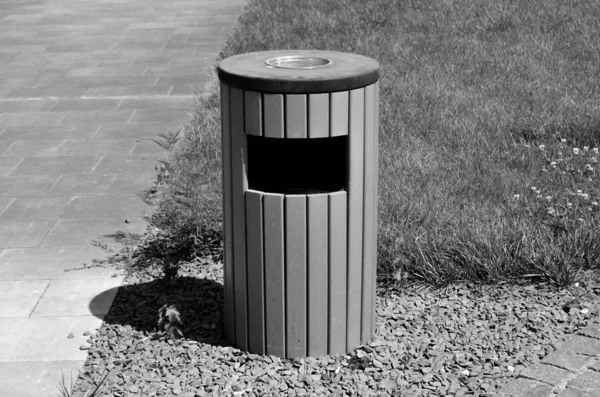 Trash can on the street, black and white