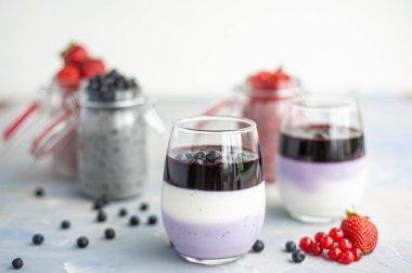 Dessert of cottage cheese, blueberries and redcurrants in glasses. clipart