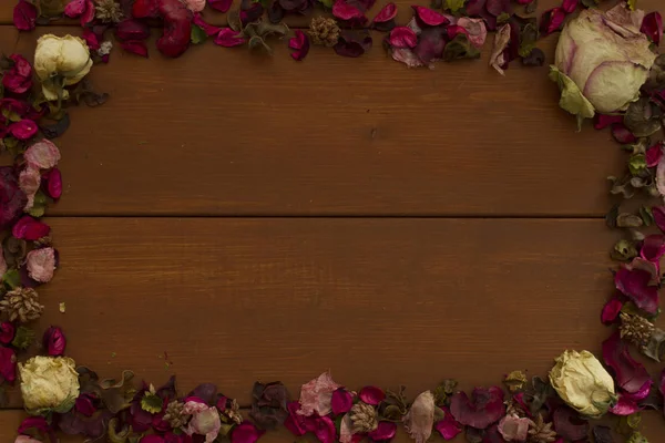 dried flowers in the shape of a photo frame on a wooden backgrounddried flowers in the shape of a photo frame on a wooden background