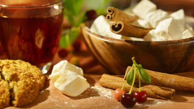 Çay, oryantal tatlılar, kiraz ve tarçın sıcak sesi ile natürmort