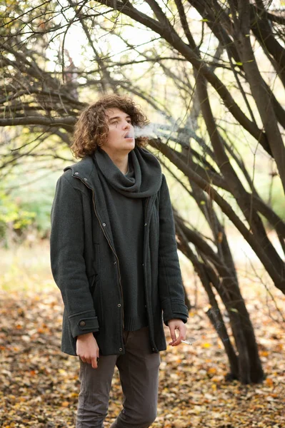 Young Man Curly Hairstyle Smoking Cigarette Blowing Cigarette Smoke Outdoor — Stock Photo, Image