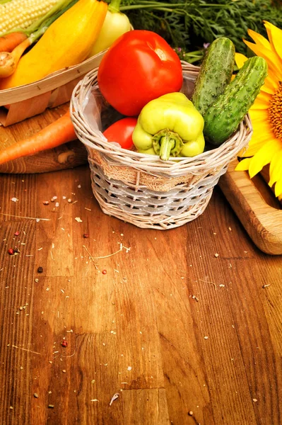 Fresh raw vegetables basket on a wooden board — Stock Photo, Image