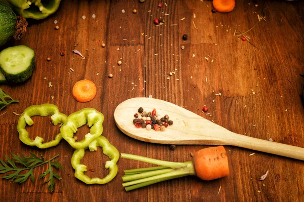 Legumes em fatias cruas e especiarias em colher de madeira em uma mesa de estilo vintage, flat lay — Fotografia de Stock