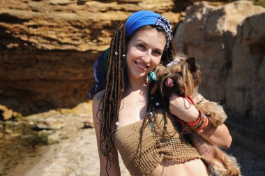 Smiling woman portrait with her yorkshire terrier dog, girl with dreadlocks clipart