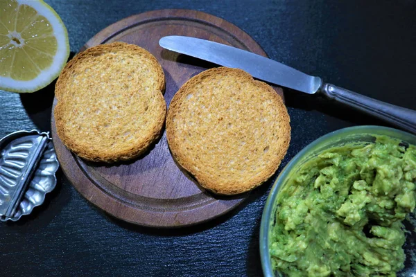 Avocado toast , overhead viewy avocado sandwich on toast bread made with fresh avocado paste on the black background