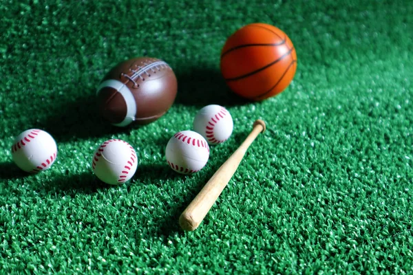 Sports accessories. sticks, balls on Green background. — Stock Photo, Image