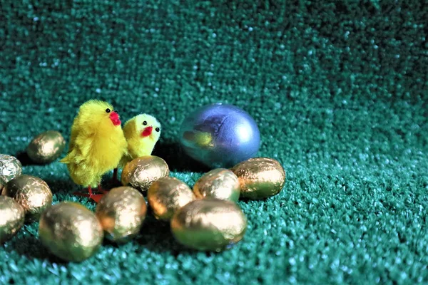 Huevos de oro en un césped artificial verde —  Fotos de Stock