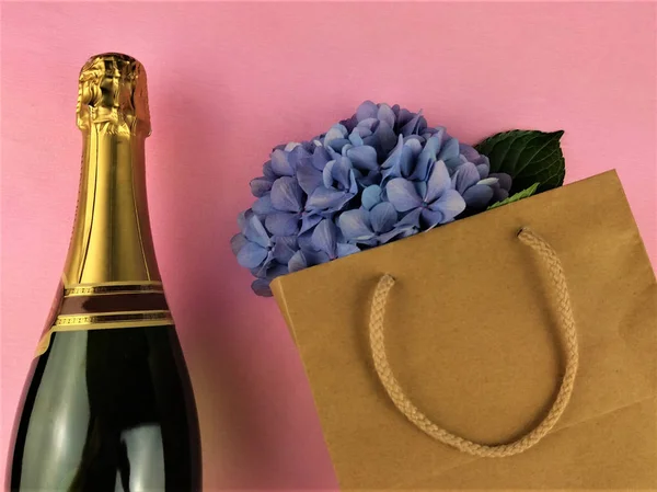Festlicher Hintergrund Champagnerflasche Und Blumen Papiertüte — Stockfoto