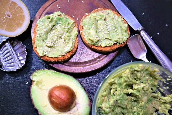 Avocado toast , overhead viewy avocado sandwich on toast bread made with fresh avocado paste on the black background