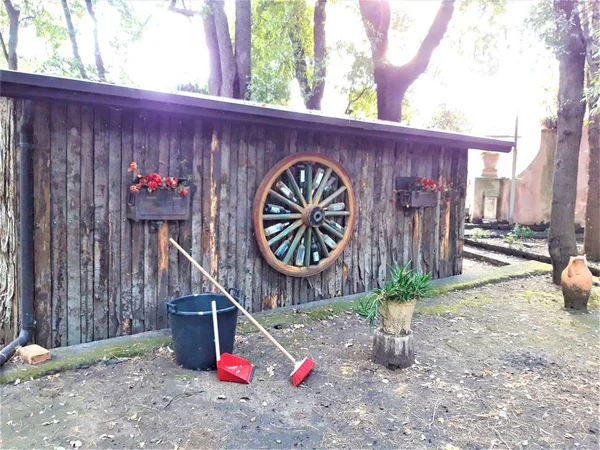 old wooden shed with garden accessories