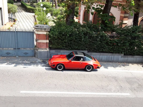 Red sports car on the street of a small Sicilian village — Stock Photo, Image