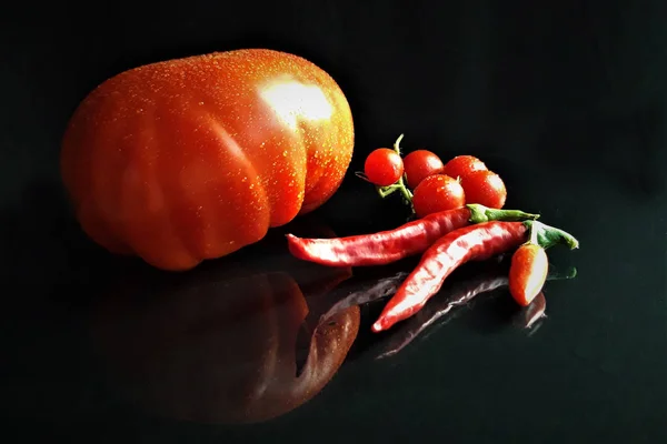 big red tomato, cherry tomatoes and red chili pepper with copy s