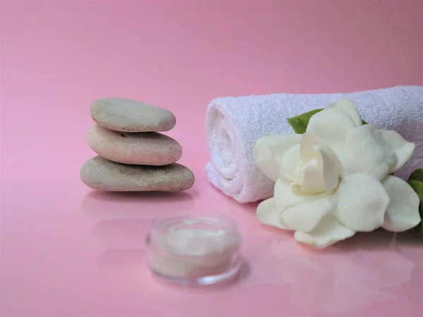 Spa setting and Spa background composition with white gardenia flower on pink background