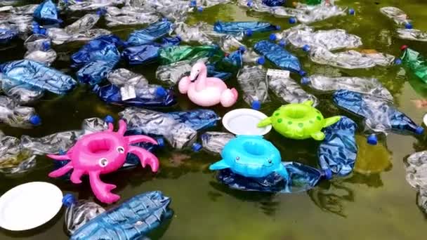 Pollution Environment Plastic Bottles Water Inflatable Toys Inflatable Pink Flamingos — Stock Video