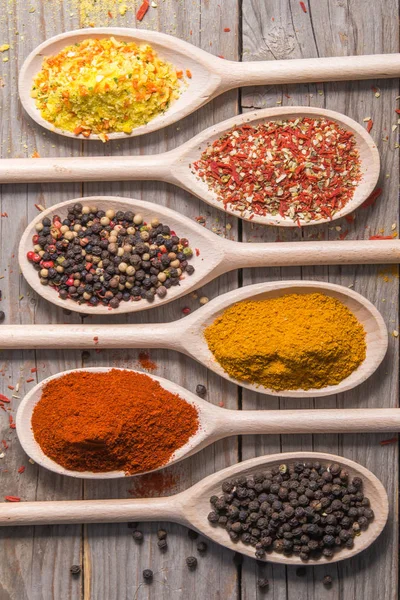 Spices of the world arranged on wooden spoons. — Stock Photo, Image