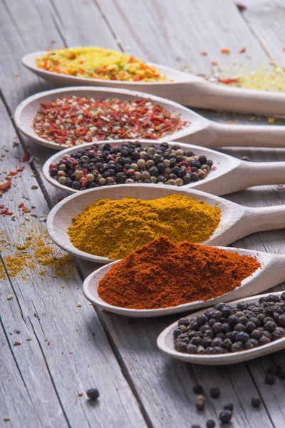 Spices of the world arranged on wooden spoons. — Stock Photo, Image