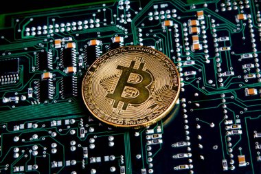 Bitcoin altın sikke yeşil ve siyah bilgisayar devre üzerinde.