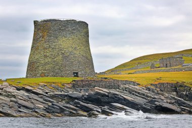 Broch of Mousa;  which is a preserved Iron Age round tower on the rocky coastline. It is on the island of Mousa in Shetland, Scotland. clipart
