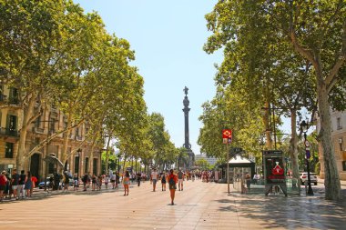 La Rambla 'dan Port Vell' deki Kristof Kolomb Anıtı 'na doğru bakın. Orta Barselona, Katalonya, İspanya 'da ağaçlarla çevrili bir yaya caddesi..