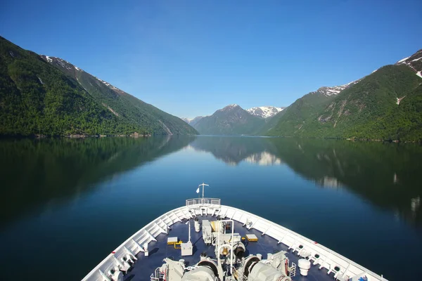 Bow or front of a ship as it cruises down the Sognefjord or Sognefjorden,  Vestland county in Western Norway. Beautiful landscape with reflections in the fjord of the mountains.