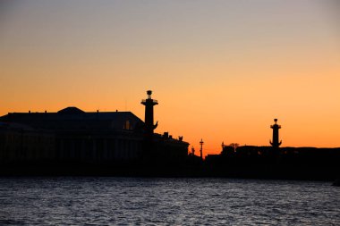 Rostral Sütunları ve gün batımında siluetteki Eski Saint Petersburg Borsası binaları Vasilievsky Adası, St Petersburg, Rusya 'nın doğu ucu olan Strelka' da yer almaktadır.. 