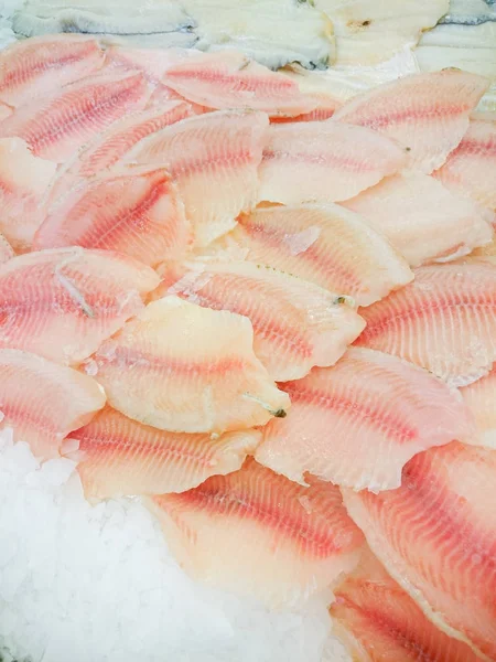 Fresh live fish on ice on open market Close-up