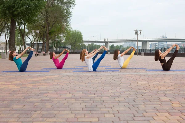 Group of women practicing yoga in park Joint trainings for yoga teachers