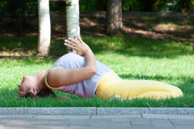 Güzel kadın yoga yaparken egzersizleri parkta Practicing yoga açık havada. Güzel genç kadın portresi pratik Yoga - doğada sakin ol
