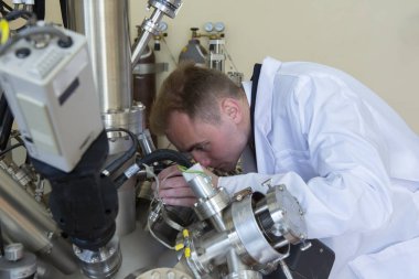 laboratory specialist examines the data obtained on a special apparatus for analyzing samples Close-up portrait clipart