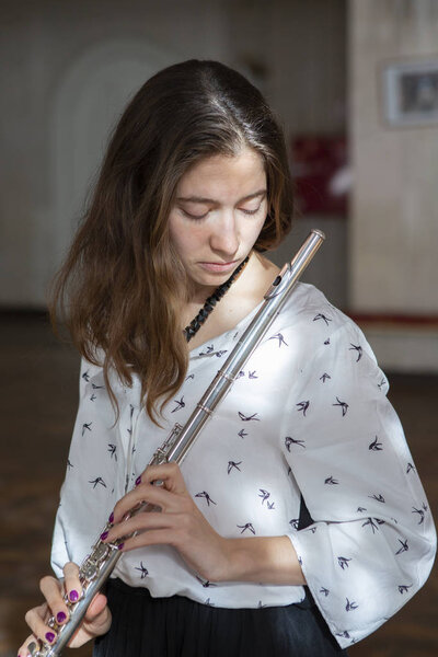 Beautiful young woman with flute Genre portrait of young beautiful girlr Close-up